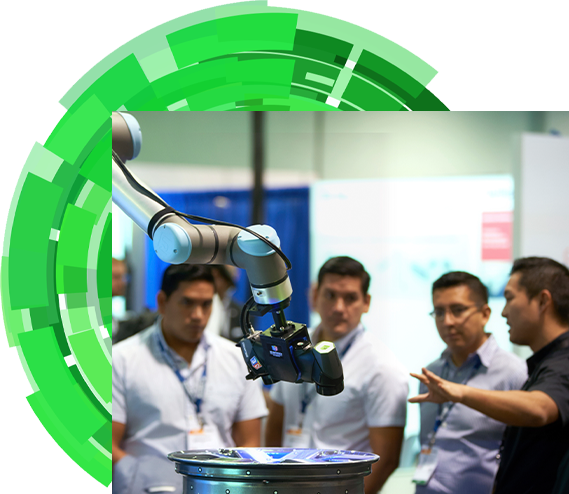An exhibitor introducing a robot to three show attendees